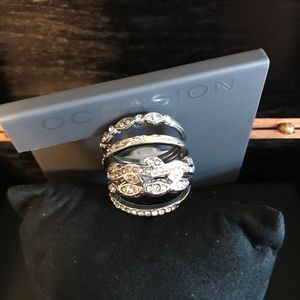 A set of 5 silver band rings with rhinestones.